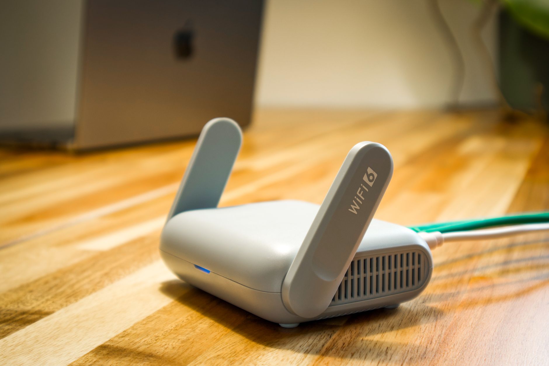 Router WiFi 6 z antenami na drewnianym biurku w domowej sieci